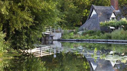 Bridge Cottage reflected in the water at Flatford